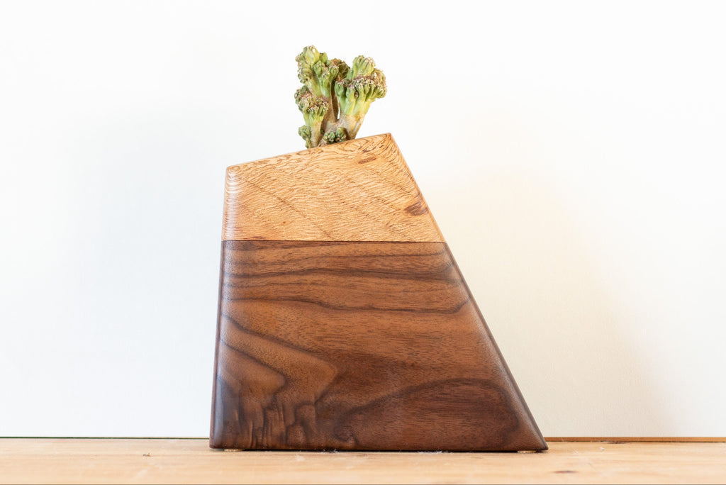 Handmade cremation urn crafted from rescued Live Oak and FSC-certified Walnut, featuring a modern geometric design with a recessed plant holder on top. Natural spalting in the Oak adds organic texture, creating a unique and living tribute.