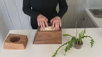 Large Planturn Cremation Urn in Walnut & Sycamore with a plant being placed inside.
